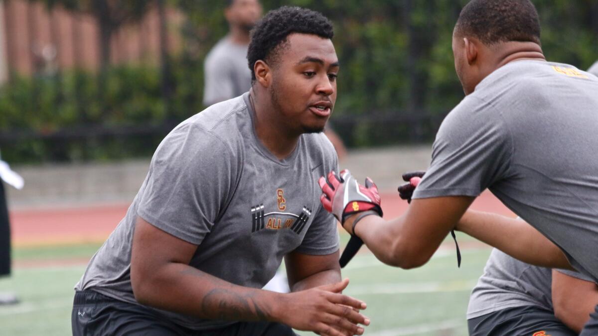 USC offensive lineman Chuma Edoga blocks during a defender during a summer workout on July 14.