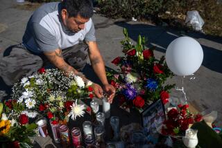 Los Angeles, CA - Jonathan Oliveros, 35, lights a candle at a sidewalk memorial for Alma Letecia Aragon and her daughter on Saturday, Nov. 25, 2023, in Los Angeles, CA. A suspected drunk driver pulled out of a liquor store across the street near on Western Avenue near 83rd Street and hit another driver who was speeding. The speeding driver then ran into 26-year-old Alma Letecia Aragon, who was walking with her 8-year-old daughter. The mother died and the child remains braindead, still fighting for her life today. Three people were hit and killed by drivers either under the influence or speeding in South Los Angeles on Thanksgiving day. (Francine Orr / Los Angeles Times)