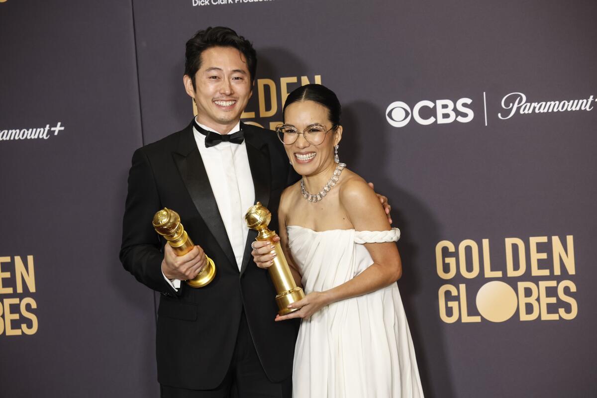 Ali Wong poses with Steven Yeun backstage at the 2024 Golden Globes