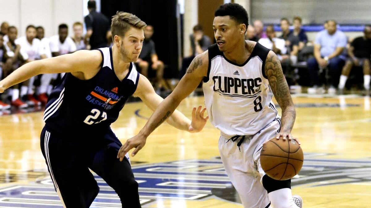 Clippers guard Diante Garrett, shown driving against Oklahoma City's Travis Bader during a summer league game Tuesday, had 20 points on Wednesday.