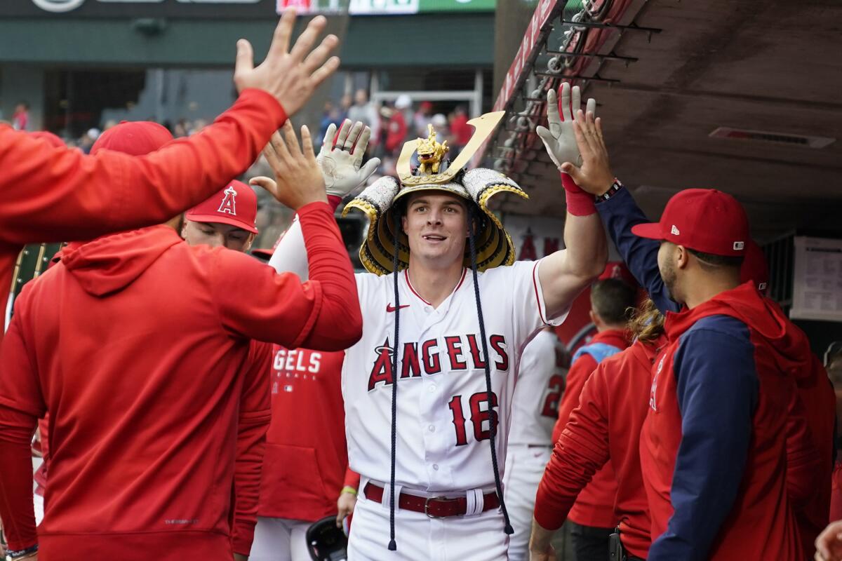 Angels' Mickey Moniak celebrates in the dugout after hitting a home run during the first inning against the Boston Red Sox.