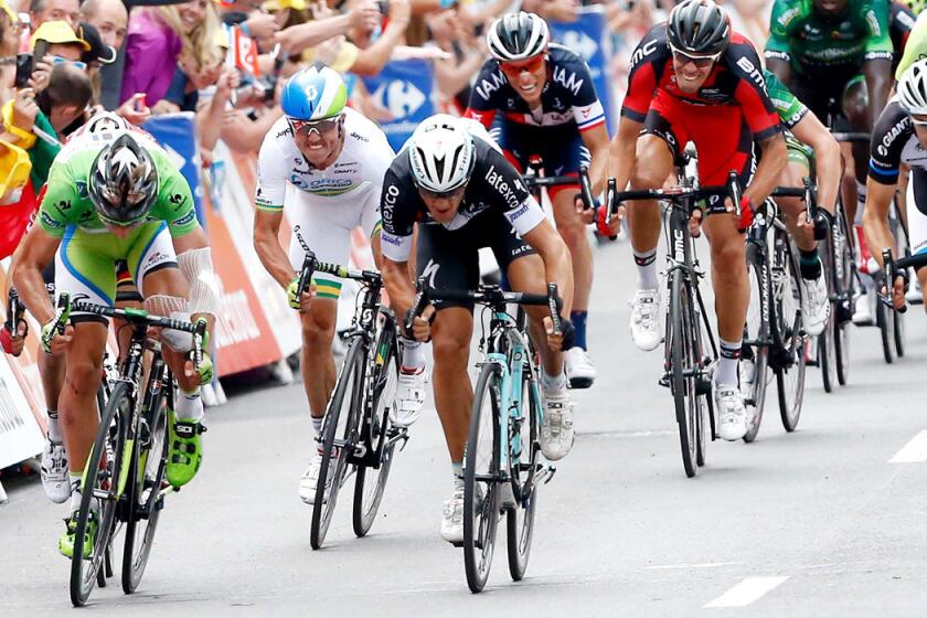 Matteo Trentin, center, edges Peter Sagan, left, at the finish line in the seventh stage of the Tour de France on Friday in Nancy, France.