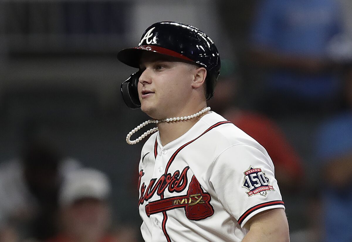 Atlanta Braves' Joc Pederson sports a pearl necklace after hitting a home run against the Mets on Oct. 2.