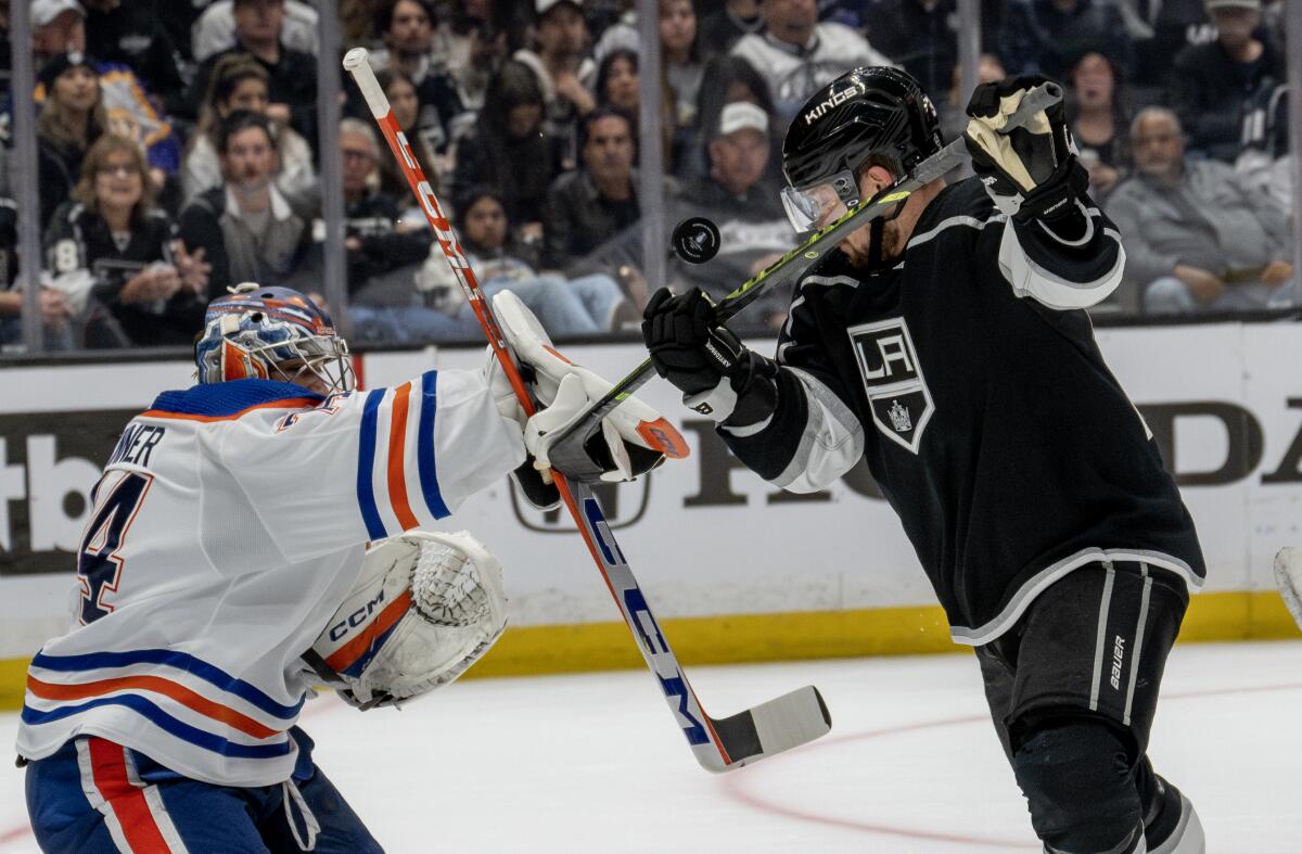 Kings forward Viktor Arvidsson battles Edmonton Oilers goaltender Stuart Skinner for a loose puck.