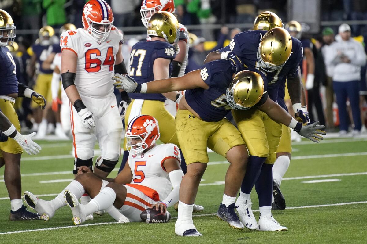 Notre Dame defensive lineman Howard Cross III takes a bow after sacking Clemson quarterback DJ Uiagalelei during the first half of an NCAA college football game Saturday, Nov. 5, 2022, in South Bend, Ind. (AP Photo/Charles Rex Arbogast)