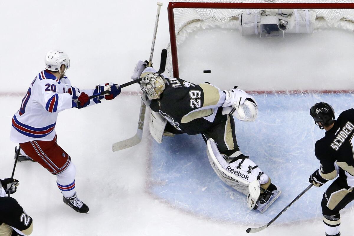 Rangers forward Chris Kreider puts the puck past Penguins goalie Marc-Andre Fleury for a second period goal. The Rangers won 2-1.