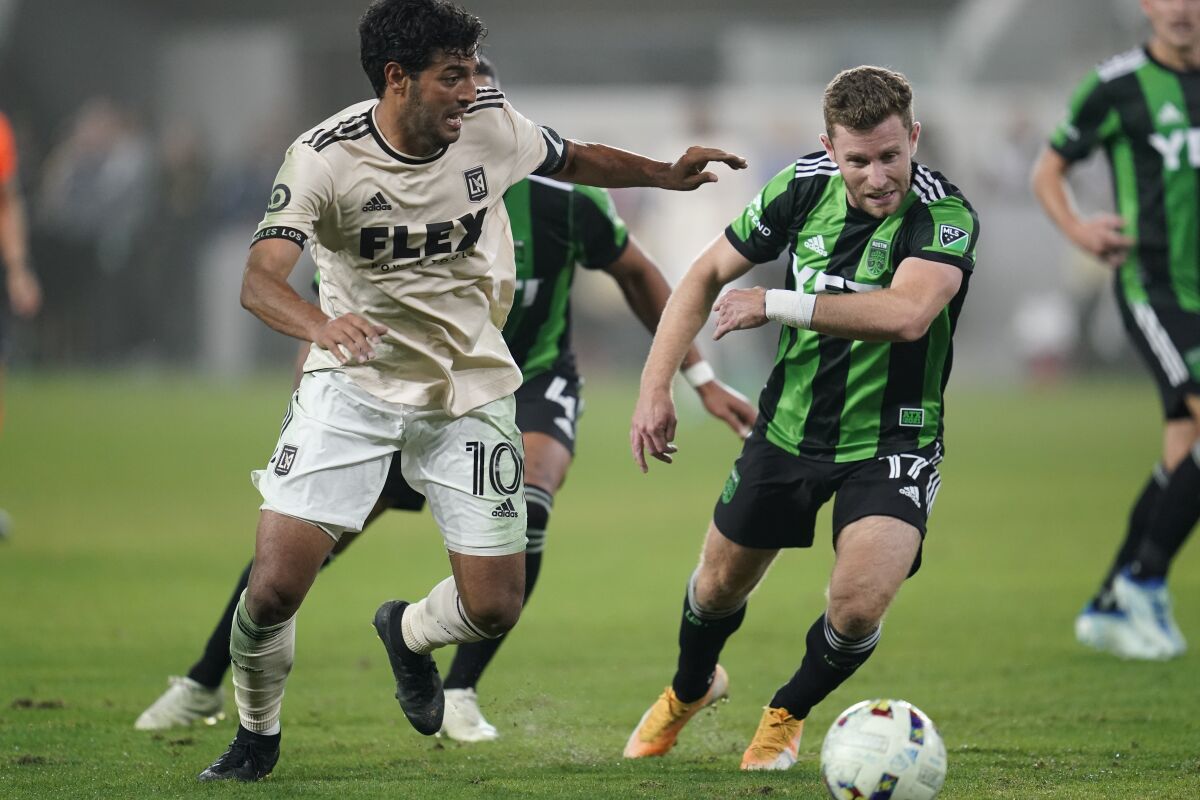 LAFC forward Carlos Vela defends against Austin FC forward Jon Gallagher.