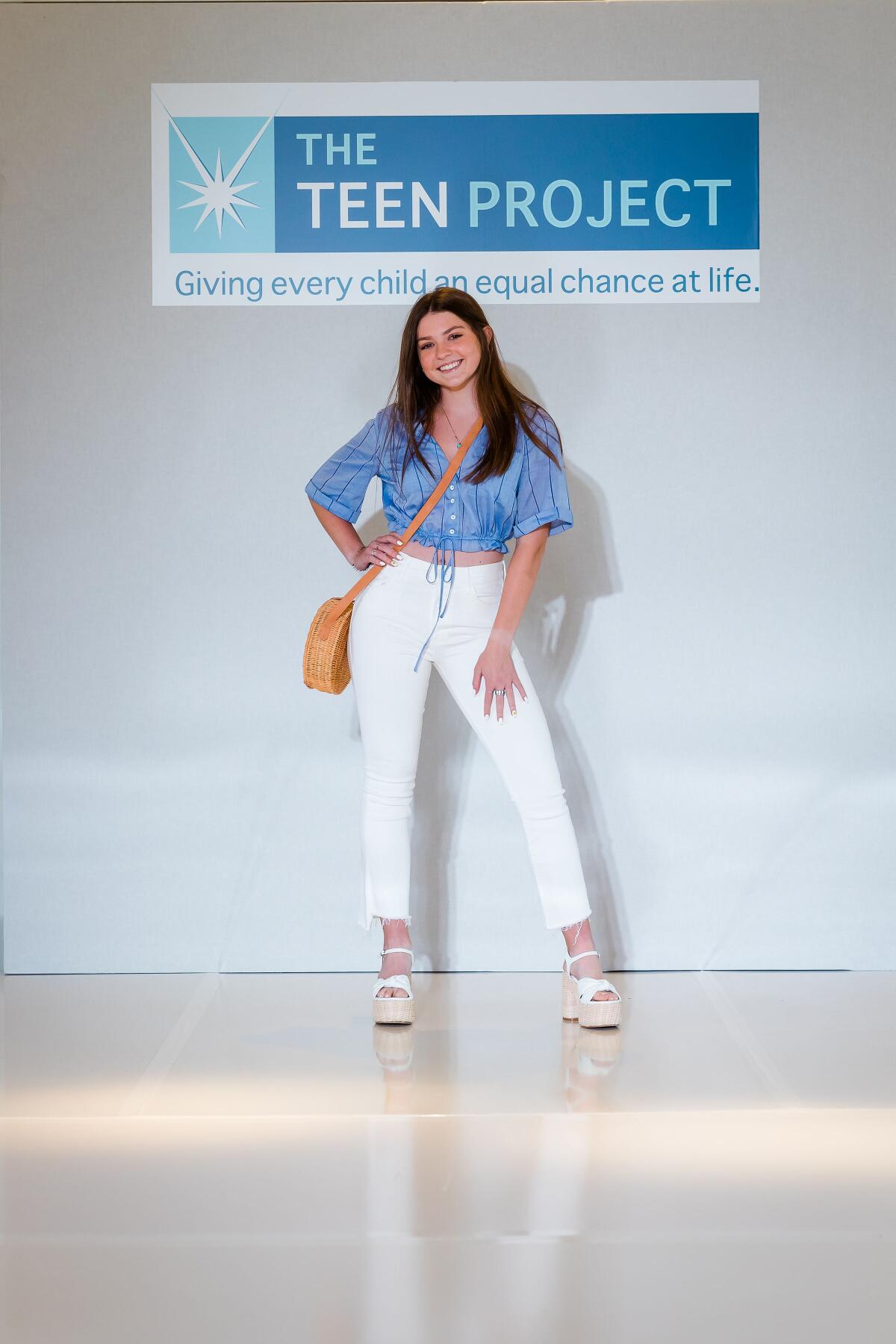 Jenny Cullen, committee member, walks the runway during the Teen Project 7th Annual Fashion Show Benefit.