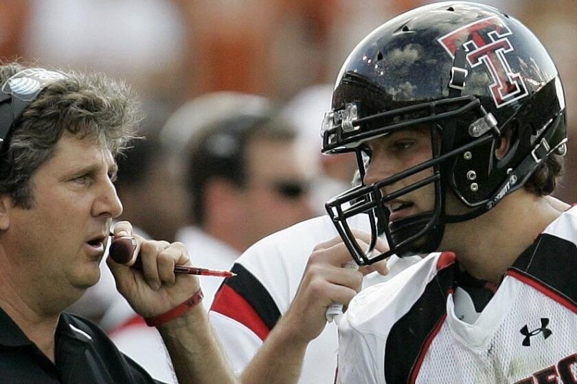 Texas Tech coach Mike Leach, left, talks with Texas Tech quarterback Graham Harrell during the second quarter of a football game in Austin, Texas, on Saturday, Nov. 10, 2007. Texas won 5943. (AP Photo/Eric Gay)