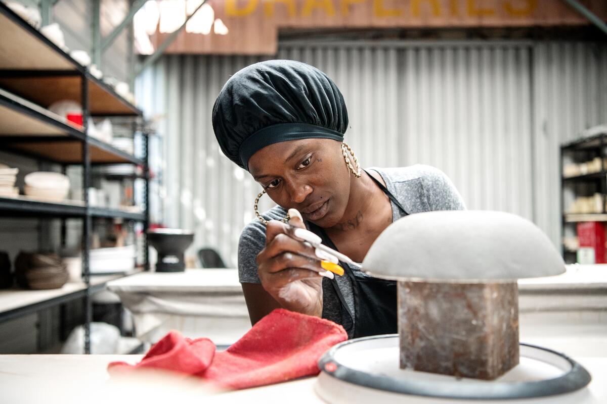 A woman works on a project in a ceramics studio.