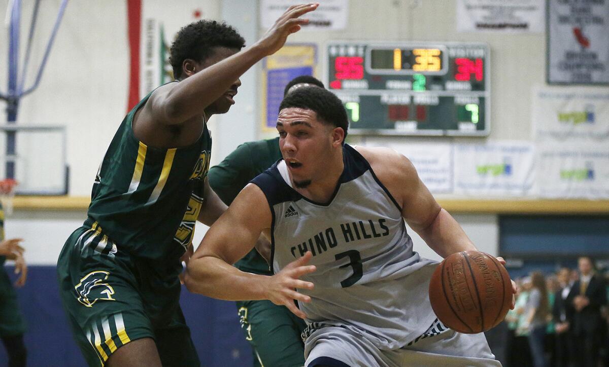 Chino Hills' LiAngelo Ball drives to the basket against Damien's Warren Bryan during a game Jan. 10.
