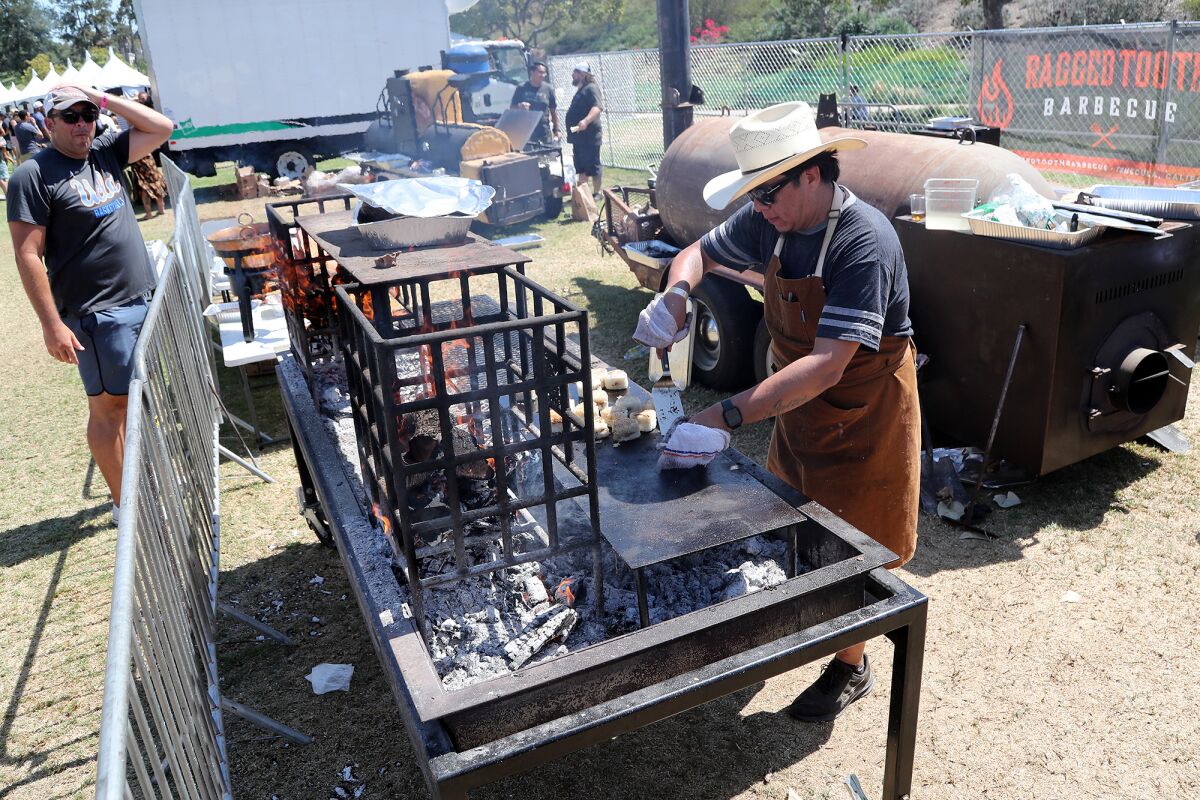 A pitmaster prepares food during the Heritage Barbecue Craft BBQ Invitational in Dana Point.