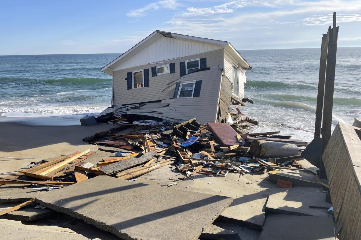 FILE - This image released by the National Park Service, shows a collapsed beachfront home along Ocean Drive in Rodanthe, N.C., on Wednesday, Feb. 9, 2022. The National Park Service issued a warning to visitors on Wednesday for debris. (National Park Service via AP, File)