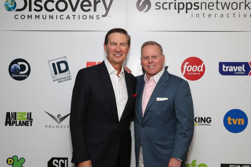 IMAGE DISTRIBUTED FOR DISCOVERY COMMUNICATIONS - Kenneth W. Lowe, Chairman, President & CEO, Scripps Networks Interactive and David Zaslav, President and CEO, Discovery Communications pictured following today's announcement that Discovery Communications will acquire Scripps Networks Interactive on Monday, July 31, 2017 in New York. (Mark Von Holden/AP Images for Discovery Communications)