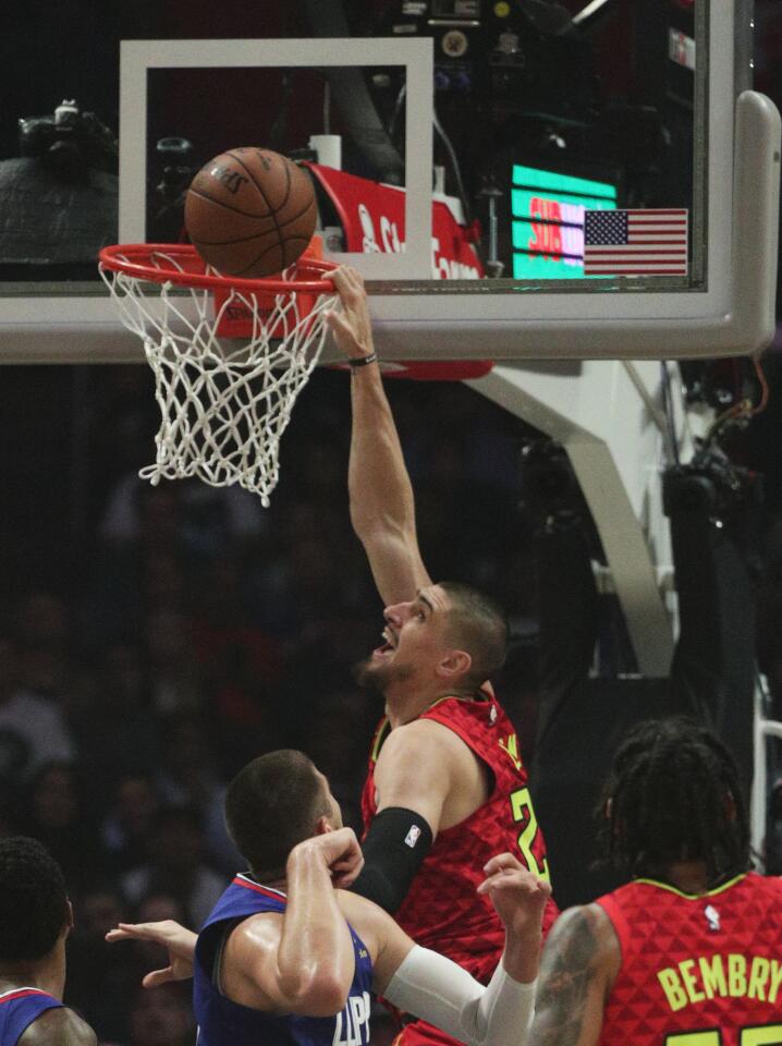 Atlanta Hawks center Alex Len dunks over Clippers center Ivica Zubac.