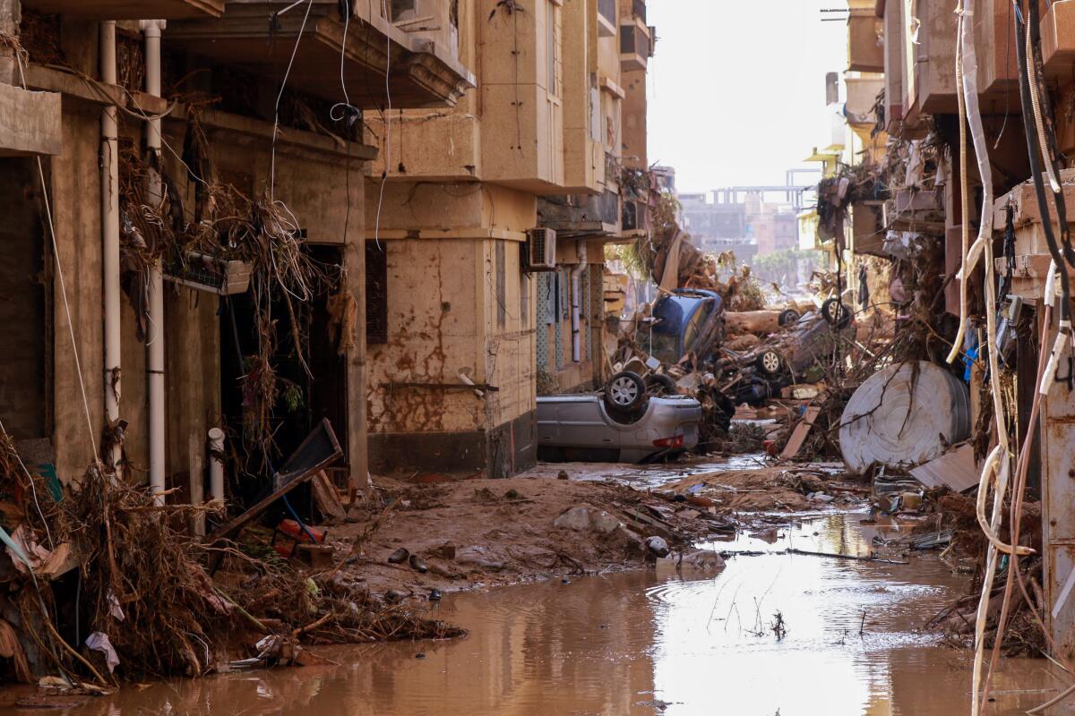 Overturned cars lie among the debris after flash floods in Derna, Libya.