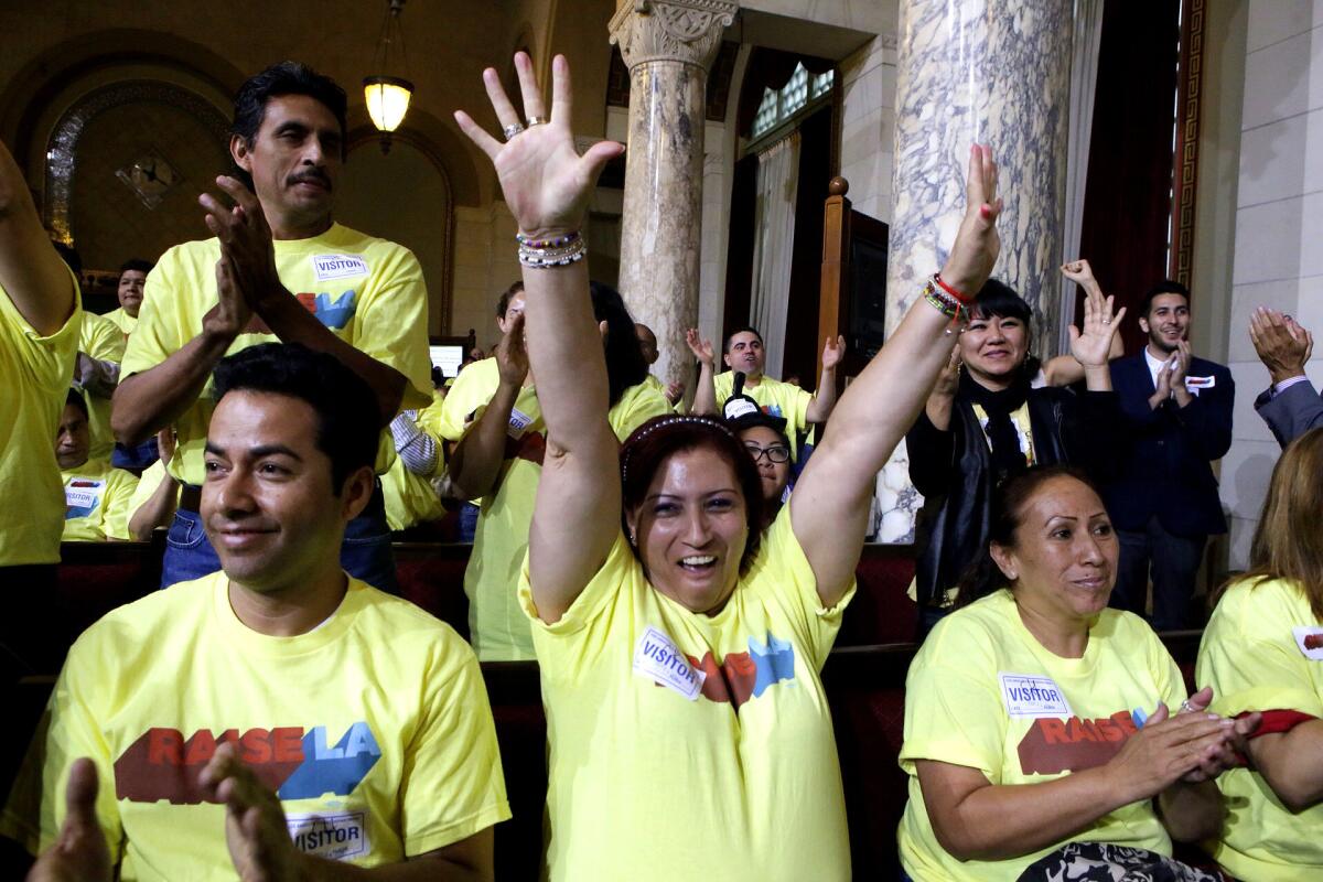 Blanca Aldama celebrates after the Los Angeles City Council tentatively approved a $15.37-an-hour minimum wage for workers at big hotels.