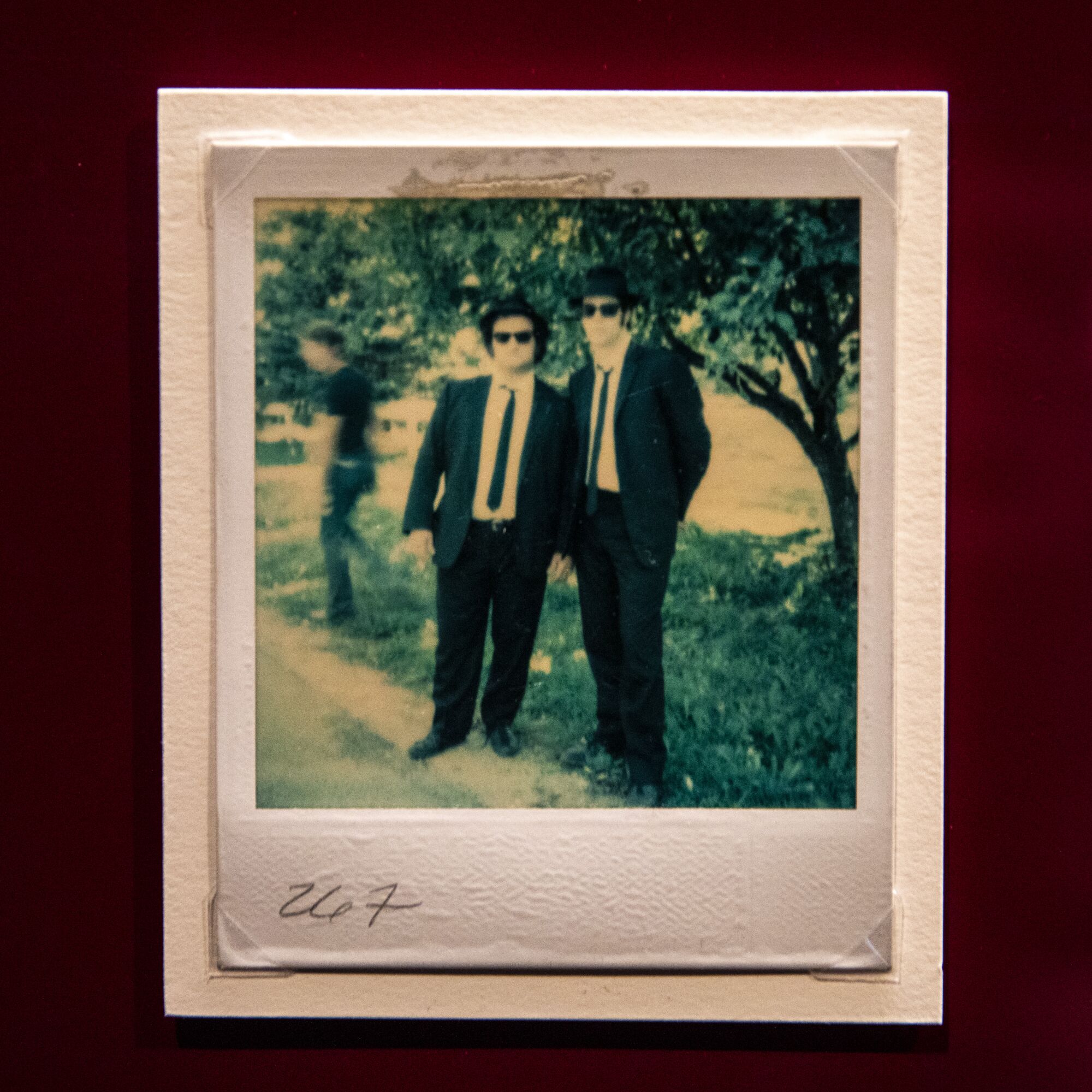 A Polaroid of two men wearing suits 
