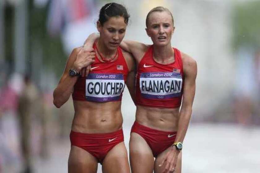 Kara Goucher and Shalane Flanagan of the United States at the finish line after completing the women's marathon.