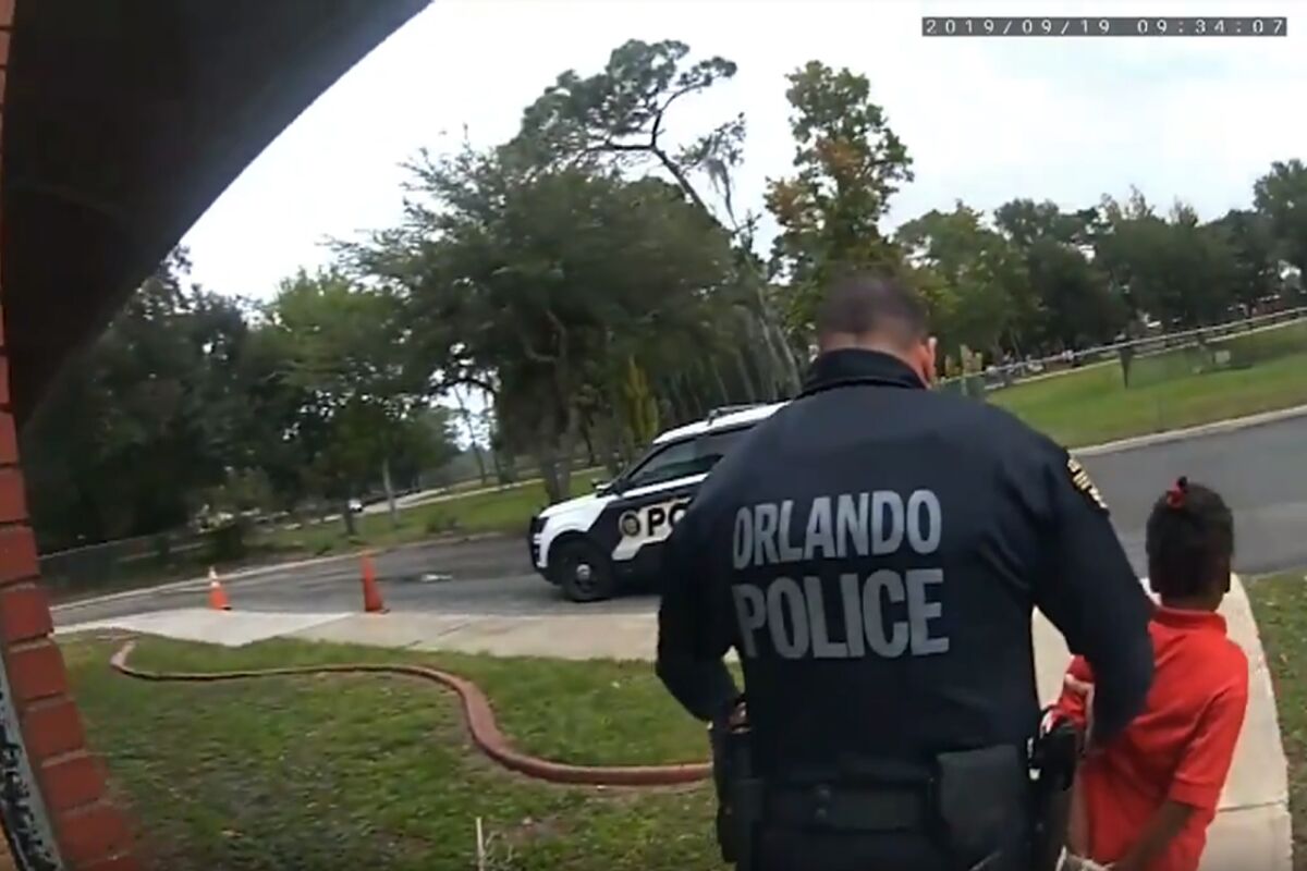 Orlando Police Officer Dennis Turner leads 6-year-old Kaia Rolle away after her arrest 