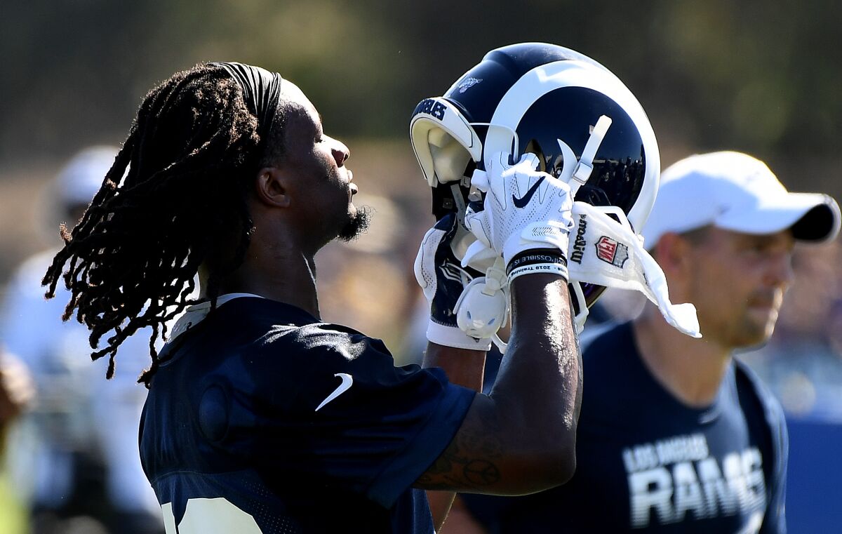 Rams running back Todd Gurley prepares to put his helmet on during training camp at UC Irvine on Saturday.