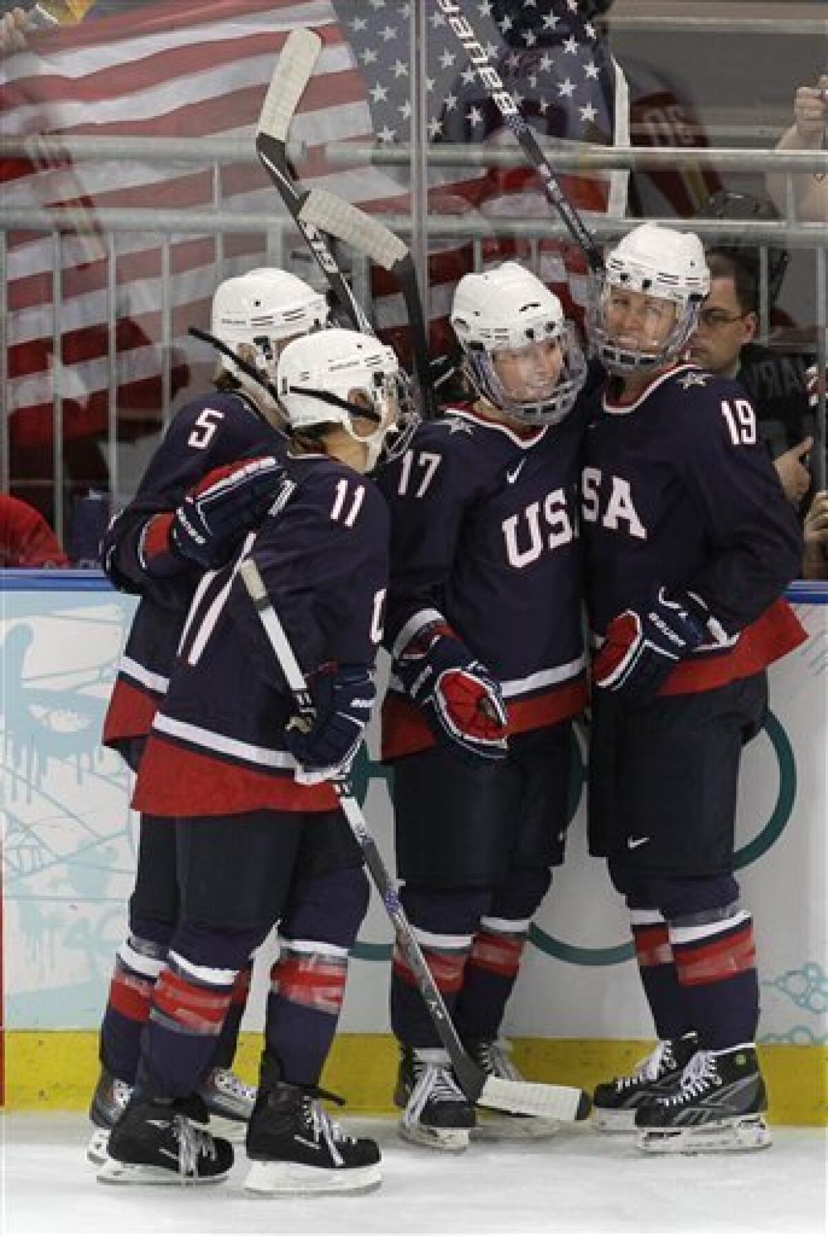 USA's forward Jocelyne Lamoureux (17) celebrates with teammates Karen Thatcher (5), Lisa Chesson (11), and Gigi Marvin (19) after scoring the USA's eighth goal against China in women's preliminary round hockey play at the Vancouver 2010 Olympics in Vancouver, British Columbia, Sunday, Feb. 14, 2010. (AP Photo/Chris O'Meara)
