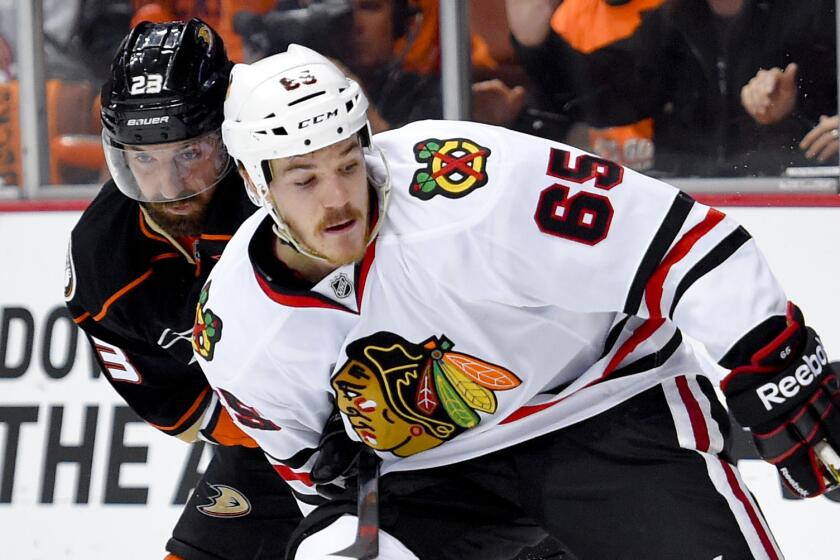 Chicago Blackhawks center Andrew Shaw (65) controls the puck in front of Ducks defenseman Francois Beauchemin during the Ducks' 3-2 loss in Game 2 of the Western Conference finals at Honda Center on May 19, 2015.