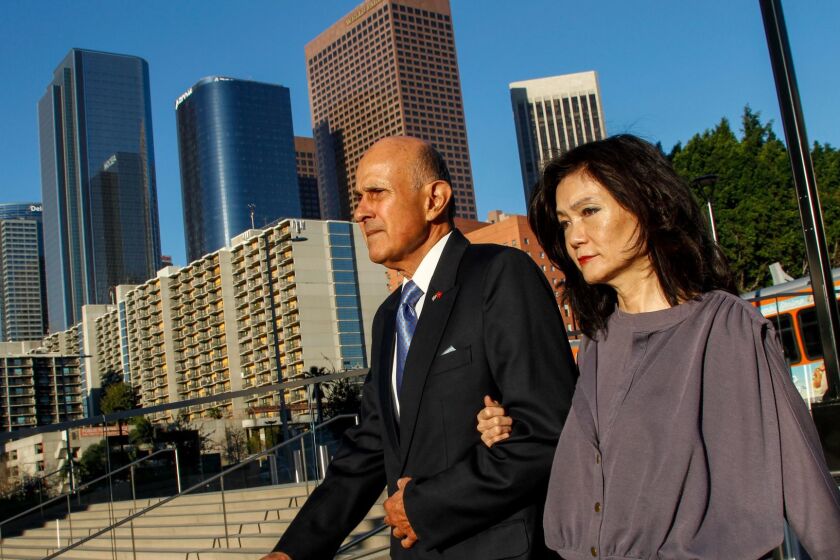 Former Los Angeles County Sheriff Lee Baca, left, with his wife, Carol Chiang, arrive at federal court earlier this month. Baca is charged with obstruction of justice, conspiracy and making false statements to federal investigators.