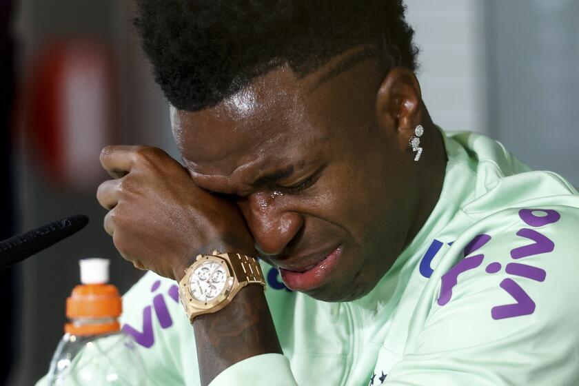 Vinicius Junior breaks down in tears during a press conference after a training session of the Brazil team ahead of a friendly soccer match against Spain on Monday March 25, 2024, in Valdebebas, Madrid, Spain. Vinicius Junior broke down in tears on Monday while talking about the racist insults that he has been subjected to in Spain, saying that he is losing his desire to keep playing because of what he has been going through. (AP Photo/Oscar J. Barroso)