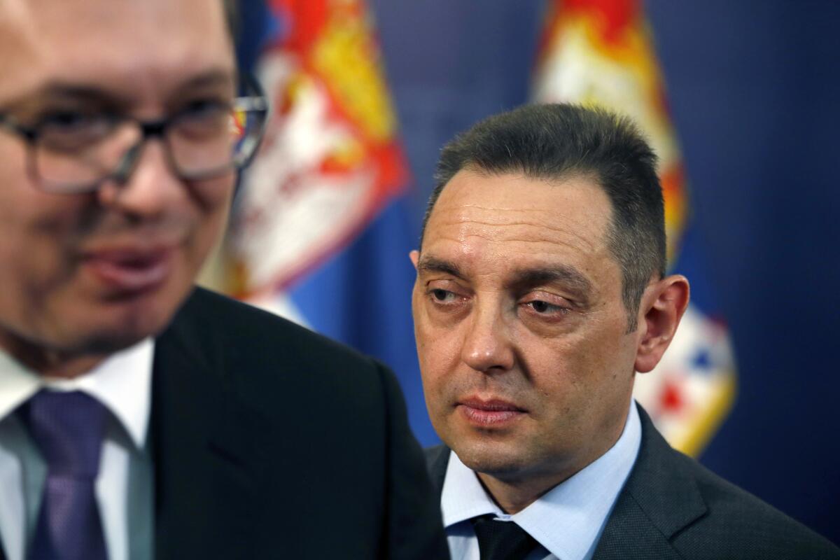 FILE - Serbia Defense Minister Aleksandar Vulin, right, walks behind Serbian President Aleksandar Vucic in Belgrade, Serbia, Monday, April 23, 2018. Vulin, said Monday, July 11, 2022 he is advocating a “Serbian world” that would unite all Serbs in the Balkans in a single state, rejecting a U.S. warning that such calls could further fuel tensions in the still volatile region. (AP Photo/Darko Vojinovic, File)