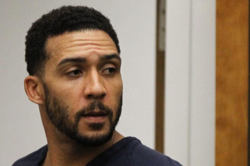 FILE - In this June 15, 2018, file photo, former NFL football player Kellen Winslow Jr., center, leaves his arraignment in Vista, Calif. Winslow, a former NFL No. 1 draft pick and son of a Hall of Famer who starred for his hometown San Diego Chargers, goes on trial Monday, May 20, 2019, on multiple charges including raping two women last year and raping an unconscious 17-year-old girl. He has pleaded not guilty to all charges.(Hayne Palmour/San Diego Union-Tribune via AP, Pool, File)