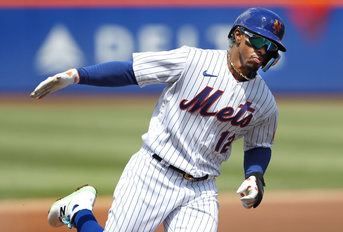 New York Mets' Francisco Lindor rounds the bases after hitting a home run against the Seattle Mariners during the first inning of a baseball game Sunday, May 15, 2022, in New York. (AP Photo/Noah K. Murray)