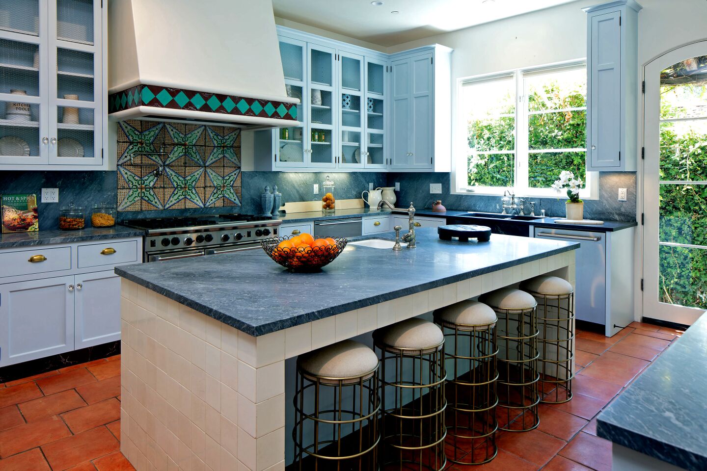 Blue-tinted stonework creates visual interest in the updated chef’s kitchen.
