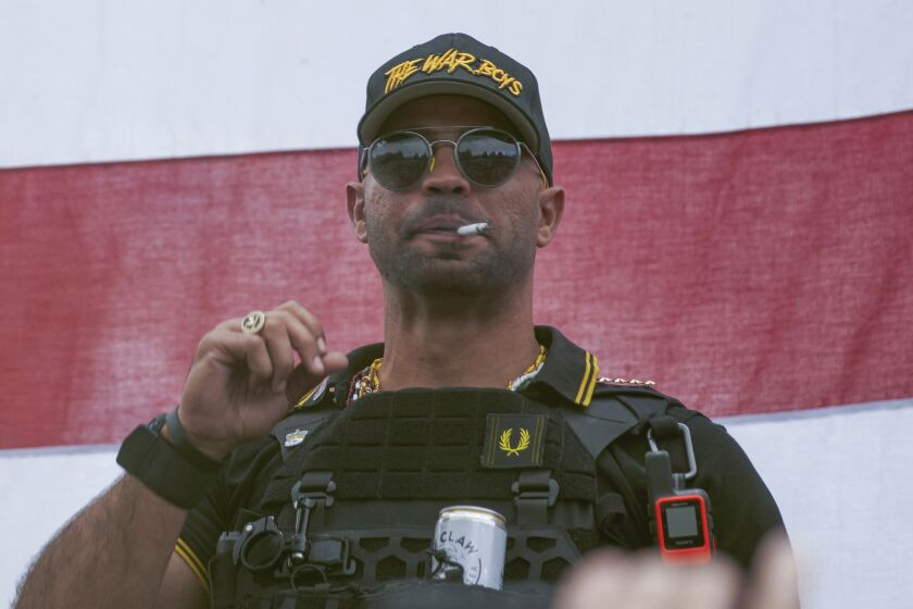 FILE - Proud Boys leader Henry "Enrique" Tarrio attends a rally in Portland, Ore., on Sept. 26, 2020. A jury has heard testimony about Tarrio's private communications with a police officer who provided him with internal information about law enforcement operations in the weeks before members of Tarrio's far-right extremist group stormed the U.S. Capitol. (AP Photo/Allison Dinner, File)