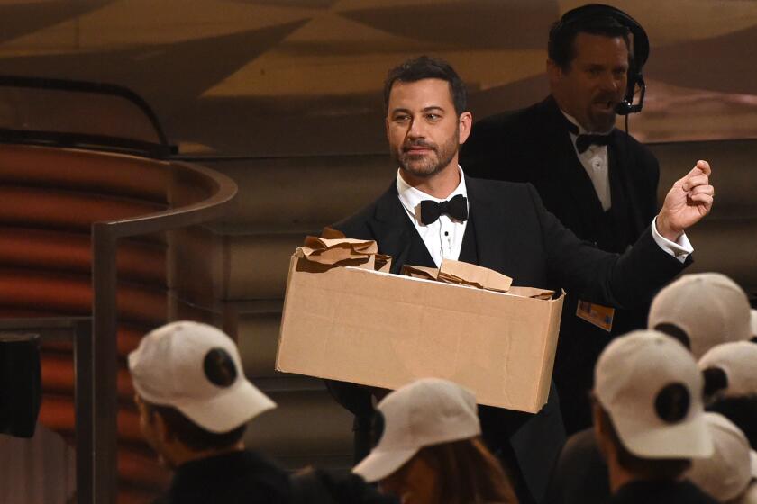 Host Jimmy Kimmel hands out peanut-butter-and-jelly sandwiches during the 68th Emmy Awards show in Los Angeles.