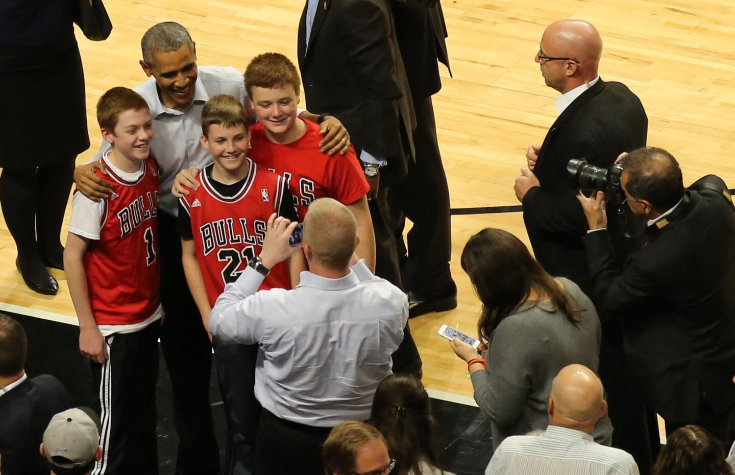 President Barack Obama poses for a photograph at a game between the Chicago Bulls and the Cleveland Cavaliers at the United Center in Chicago on Oct. 27, 2015.