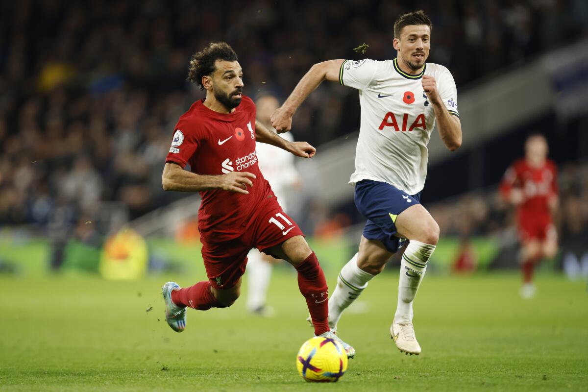 Liverpool's Mohamed Salah, left, challenges for the ball with Tottenham's Clement Lenglet during the English Premier League soccer match between Tottenham Hotspur and Liverpool at Tottenham Hotspur Stadium, in London, Sunday, Nov. 6, 2022. (AP Photo/David Cliff)