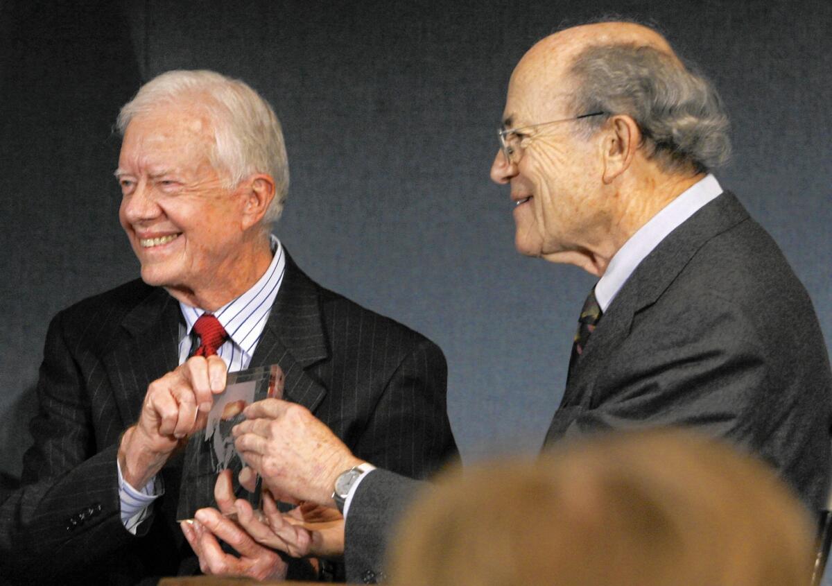 Former President Jimmy Carter, left, is presented the Ridenhour Courage Prize by Rabbi Leonard Beerman in Washington in 2007.
