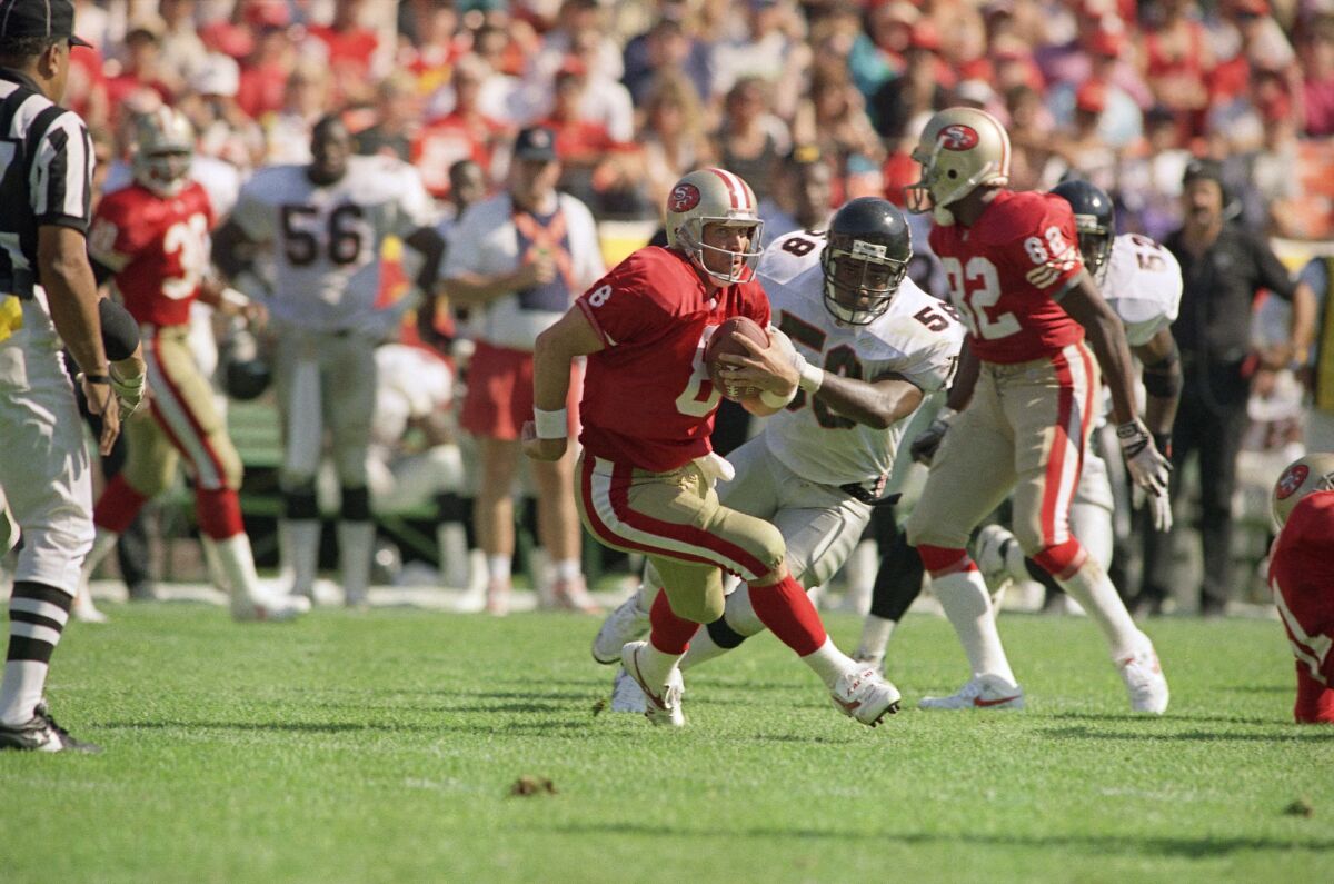 San Francisco 49ers quarterback Steve Young (8) scrambles against Atlanta in 1991.