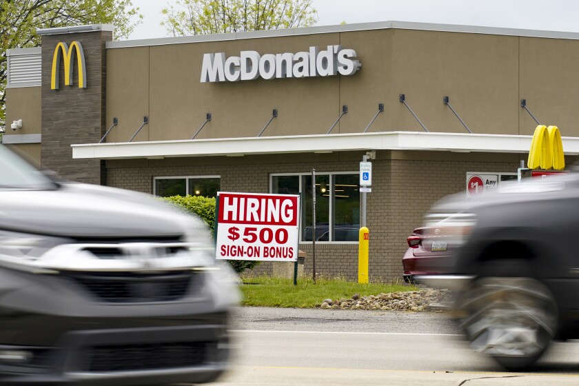 A sign offers a $500 hiring bonus outside a McDonald's restaurant 