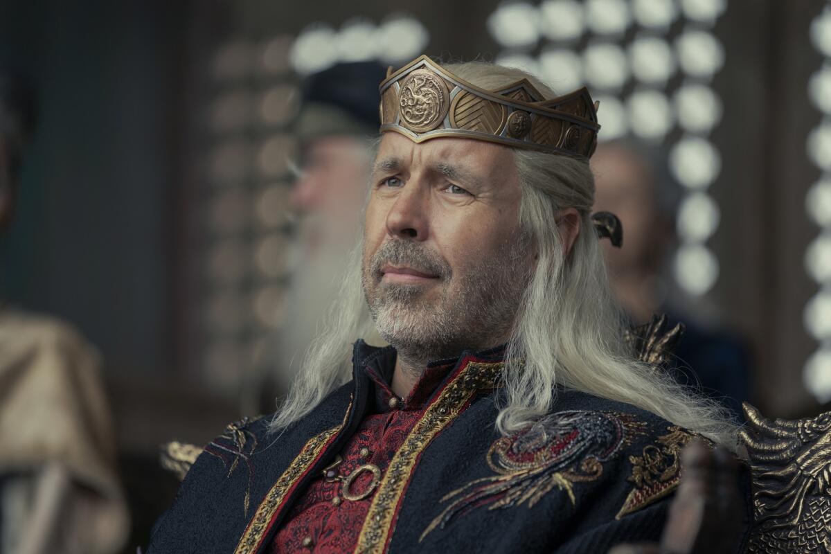 A man with long white hair wearing a crown and an ornate outfit in "House of the Dragon."