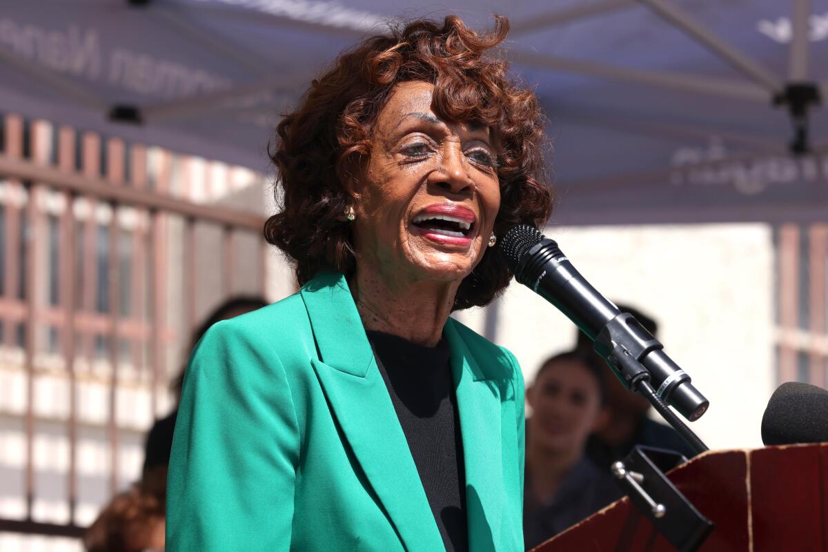 Rep. Maxine Waters speaks at a lectern