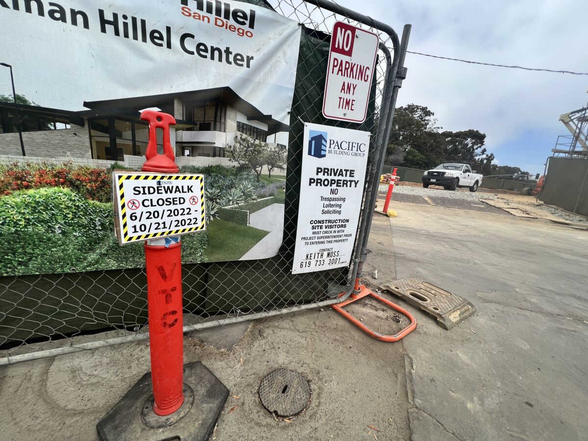 A sign at the end of La Jolla Scenic Drive North at Cliffridge Avenue indicates the sidewalk to Torrey Pines Road is closed.