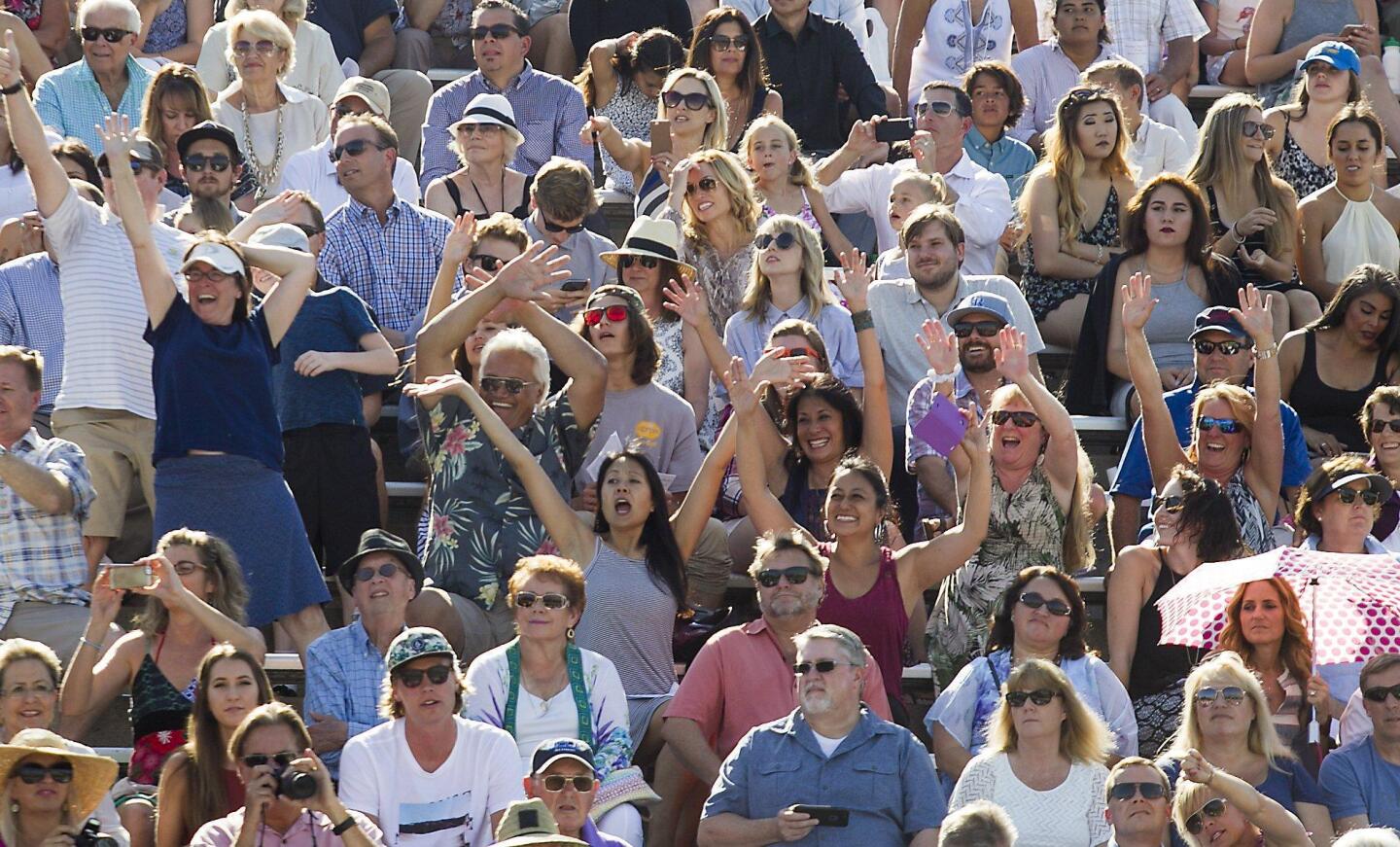 Family and friends cheer for a graduate during the 2016 commencement ceremony for Newport Harbor High School at Orange Coast College on Thursday.