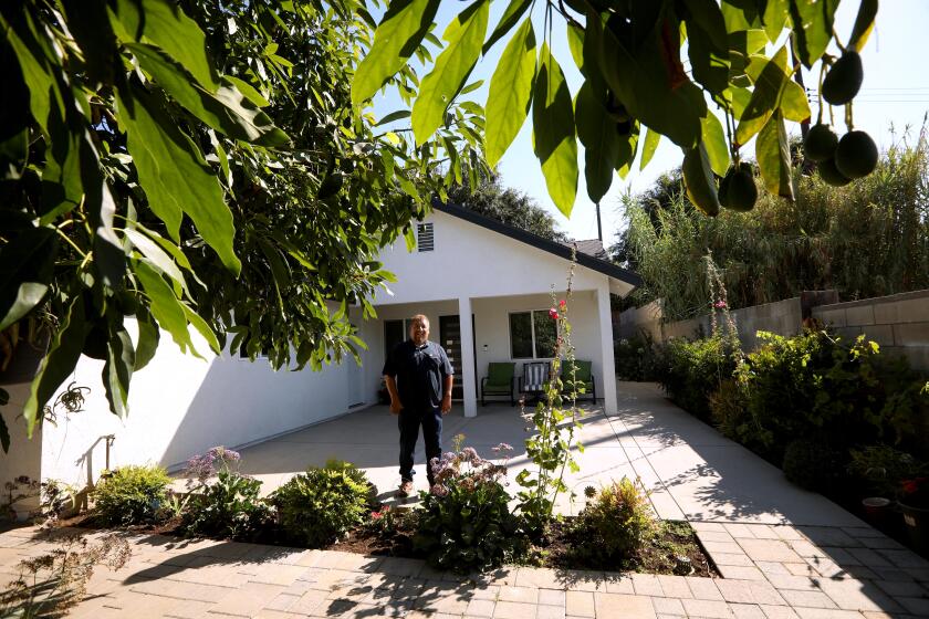 SAN FERNANDO VALLEY, CA - JULY 20, 2024 - Contractor Hector Lopez, 55, stands in front of the ADU he built for his daughter in the San Fernando Valley on July 20, 2024. It took eight months to build the 1200 square foot property. "Right now what's really pushing are ADU's," Lopez said. Lopez' family business, Bluejay Construction, has built 3 ADUs so far for family members. (Genaro Molina/Los Angeles Times)