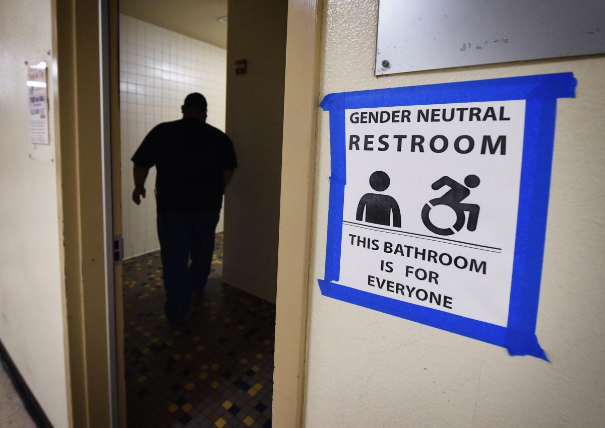 A sign posted outside a gender-neutral restroom at Santee High School in Los Angeles is shown in this file photo taken on May 4, 2016.