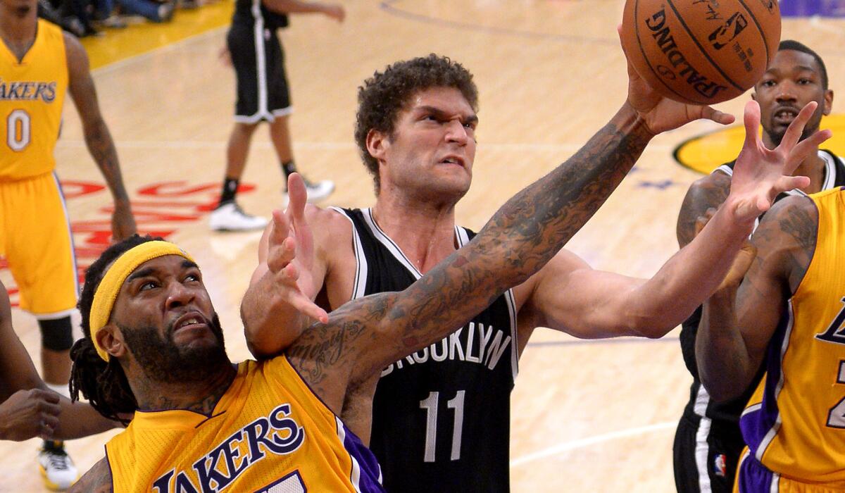 Lakers center Jordan Hill and Nets center Brook Lopez vie for a rebound in the second half.