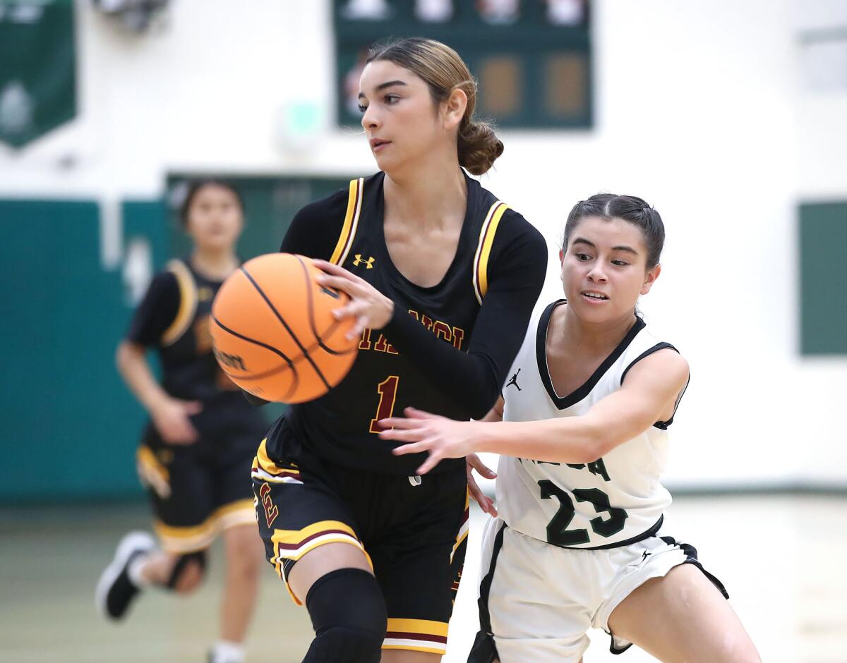 Costa Mesa's Myah Martinez tries to steal the ball from Estancia's Andrea Meza.