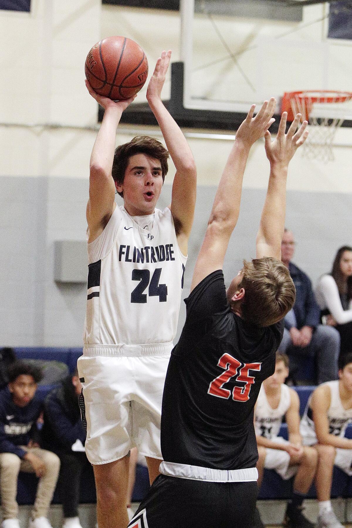 Flintridge Prep's Dylan Mealey pulls up for a jump shot against South Pasadena's Mickey Ebner in a non-league boys' basketball game at Flintridge Preparatory School on Monday, January 6, 2020.