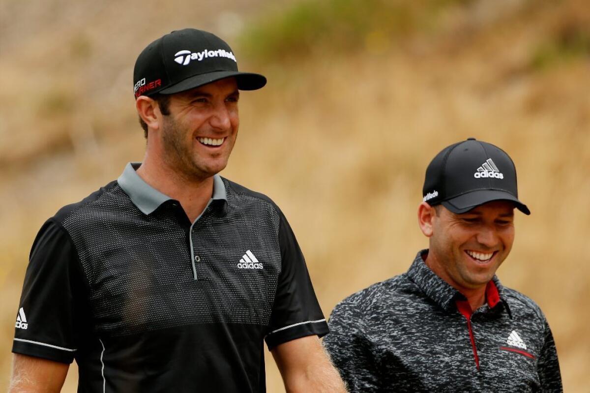 Dustin Johnson and Sergio Garcia share a smile during the first round of the 115th U.S. Open at Chambers Bay Golf Club in University Place, Wash.